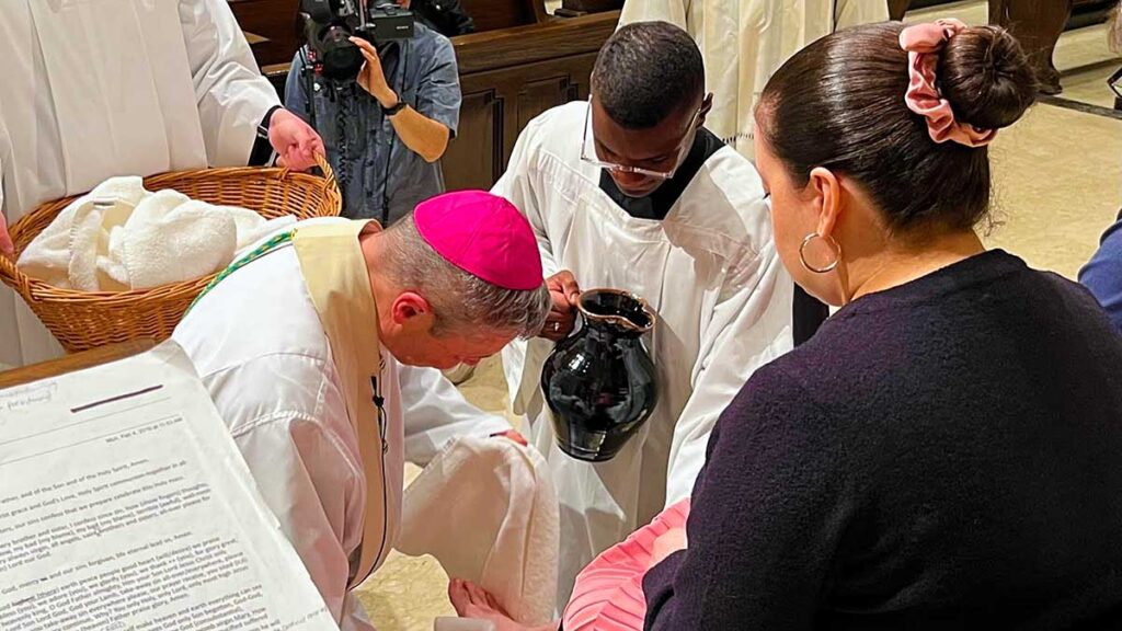 Bishop brennan presides over the mass of the lords supper and washes the feet of twelve to represent the apostles kat