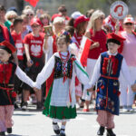 The Polish Constitution Day Parade, Children wearing traditional polish clothing walking down the street during the parade — Photo by RobertoGalan