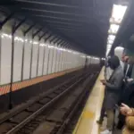 NYC commuters waiting in station