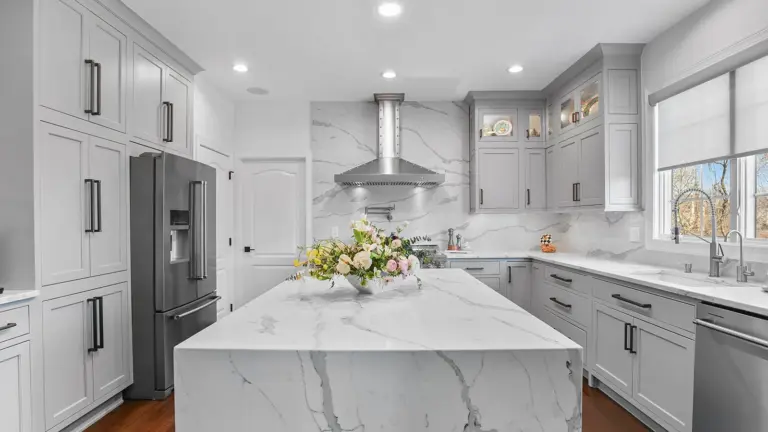Kitchen island with a stone countertop in a bright kitchen