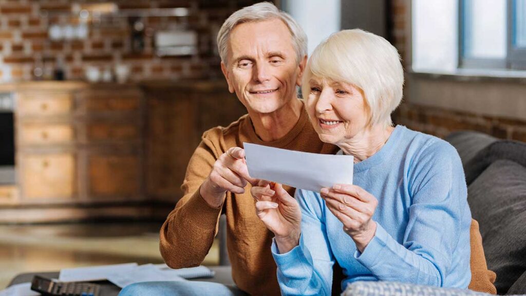 Senior couple reading documents at home – when you won't get Social Security benefits