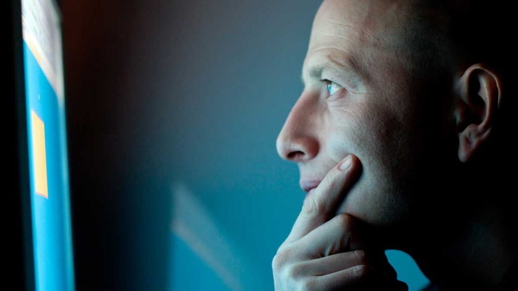 Thoughtful man looking at a screen – who can check your background
