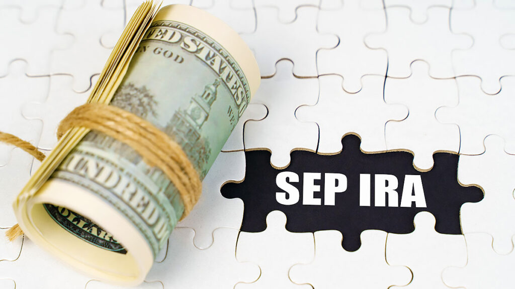 Roll of dollars and a SEP IRA puzzle piece – retirement savings for the self-employed