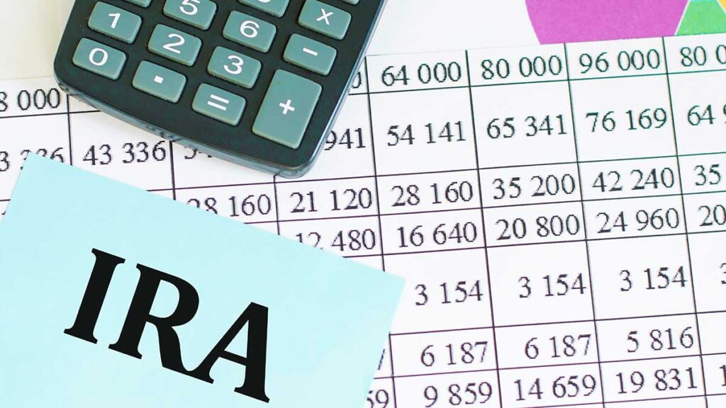IRA note on a tax table with a calculator – IRA accounts and filing taxes